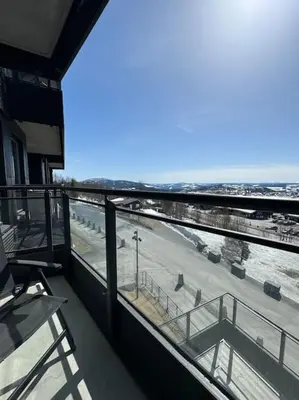 a balcony of a building with a view of the ocean at Riddertunets utsikt til Mugnetind in Beitostøl