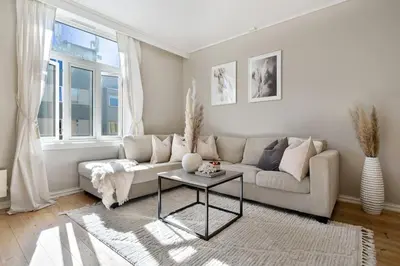 a living room with a couch and a table at Sentral og koselig leilighet i Trondheim in Trondheim