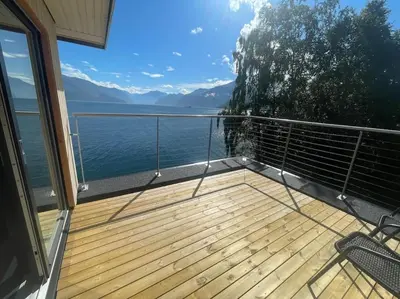 a balcony of a house with a view of the water at Amazing View in Stranda