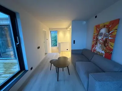 a living room with a blue couch and a table at Amazing View in Stranda