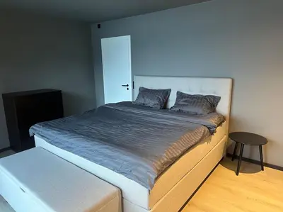 a bedroom with a large bed with a stool next to it at Amazing View in Stranda