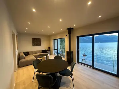 a living room with a table and a large window at Amazing View in Stranda