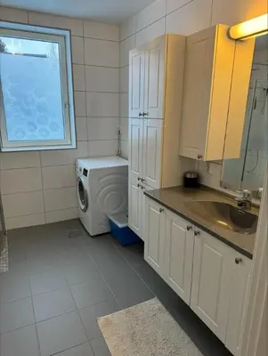 a kitchen with a washing machine and a window at Skyttarbakken 57 in Heimdal