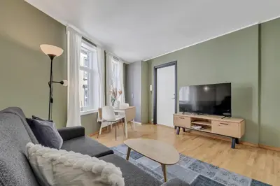 a living room with a couch and a flat screen tv at City Retreat in Bergen