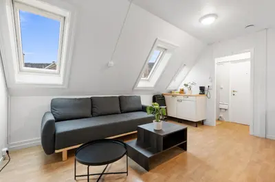 a living room with a couch and a table at City center apartment with teracce in Bergen