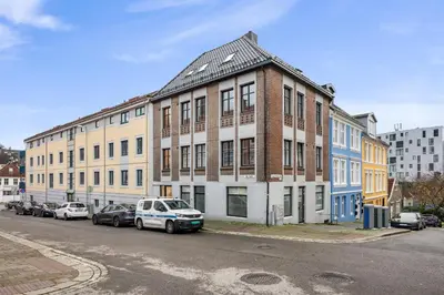 a building with cars parked on the side of a street at City center apartment with teracce in Bergen
