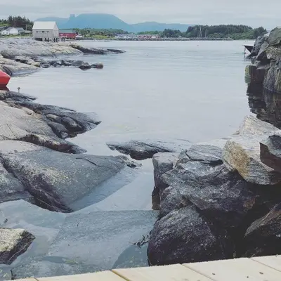 a view of a body of water with rocks at Det lille huset i Slipveien in Bud