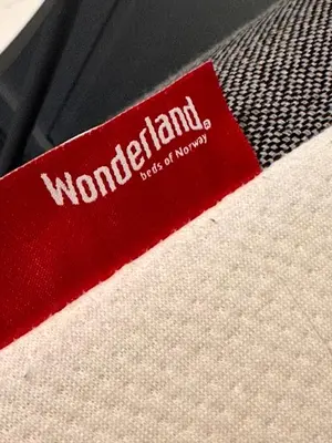 a red tag with the word feminism on a tie at Det lille huset i Slipveien in Bud