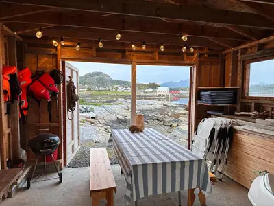 a room with a table and a view of the ocean at Det lille huset i Slipveien in Bud