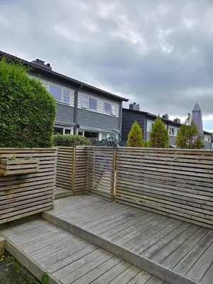 a wooden fence in front of a house at Exclusive three-story villa near the ski center in Trondheim