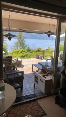 a screened in porch with a view of the water at PARADISET - a beautiful pearl 1,45 minutes from Trondheim in Surnadal