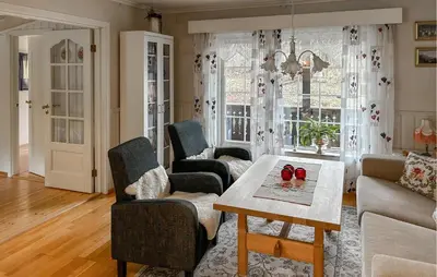 a living room with a table and two chairs at Lovely Home In Lena With Wifi
