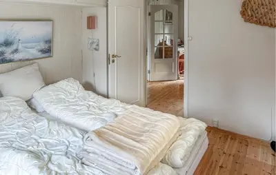 an unmade bed in a room with at Lovely Home In Lena With Wifi