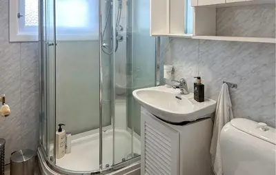 a bathroom with a shower and a sink at Lovely Home In Lena With Wifi