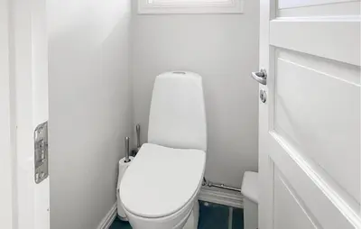 a bathroom with a white toilet in a room at Nice Home In Oppdal With Sauna in Oppdal