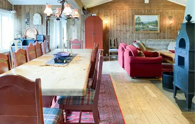 a dining room with a long wooden table and chairs at Nice Home In Oppdal With Sauna in Oppdal