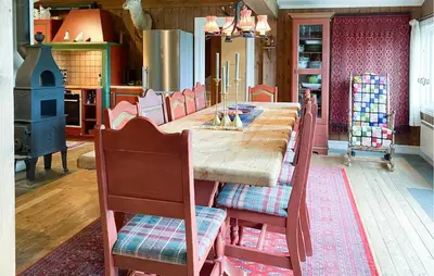 a dining room with a long wooden table and chairs at Nice Home In Oppdal With Sauna in Oppdal