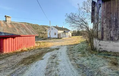 a dirt road next to a white house and a red building at Beautiful Home In Vestre Gausdal in Vestre Gausdal