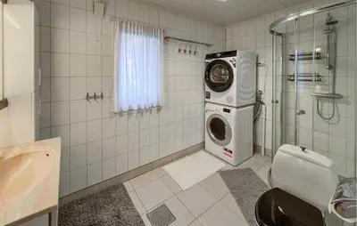 a bathroom with a washing machine in a shower at Beautiful Home In Vestre Gausdal in Vestre Gausdal