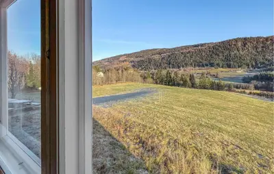 a view of a field from a window at Beautiful Home In Vestre Gausdal in Vestre Gausdal