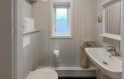 a bathroom with a sink and a toilet and a window at Awesome Home In Lillehammer With Sauna in Lillehammer