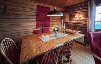 a dining room with a wooden table and chairs at Awesome Home In Lillehammer With Sauna in Lillehammer