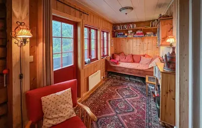 a room with a bed and a couch in a train room at Awesome Home In Lillehammer With Sauna in Lillehammer