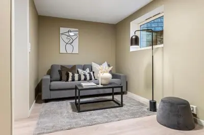 a living room with a couch and a table at Flott bolig til VM! Gåavstand in Trondheim
