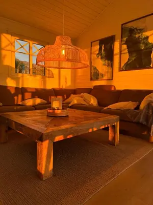 a living room with a couch and a wooden coffee table at Paradise by the Seaside in Hitra