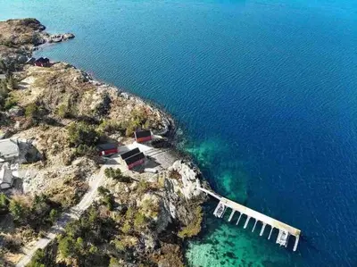 an aerial view of a mountain with the ocean at Paradise by the Seaside in Hitra