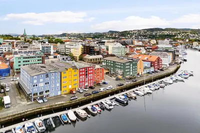 an aerial view of a city with boats in a harbor at Charming Loft, High Ceiling !Modern & Central, Free private Parking 7 min walking ! in Trondheim