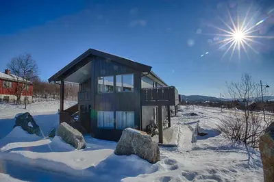 a small house in the snow with rocks at A Family-Friendly, Pet-Friendly Getaway In Beitostølen Center in Beitostøl