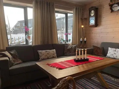 a living room with a couch and a table with candles at A Family-Friendly, Pet-Friendly Getaway In Beitostølen Center in Beitostøl