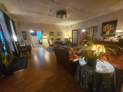 a living room with a couch and a table at Eides Hotel in Høyanger