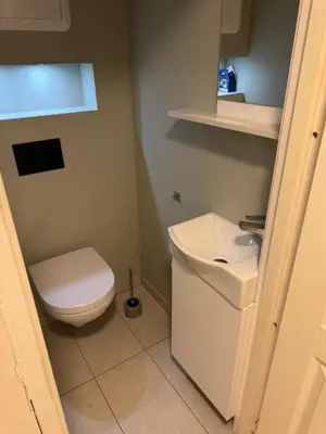 a bathroom with a toilet and a sink at Ålesund room with shared shower in Ålesund