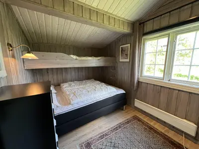 a small bedroom with a bed in a room at Welcoming Cabin With Fireplace & Modern Kitchen in Beitostøl