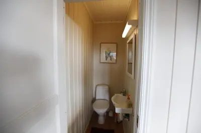 a small bathroom with a toilet and a sink at Charming Getaway ,Near Ski Trails And Hiking Paths in Beitostøl