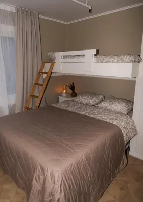 a bedroom with two bunk beds and a ladder at Huset Vårt - Bed and Breakfast in Hornindal