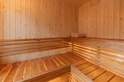 a large empty sauna with wooden walls and wooden floors at Exclusive fjord getaway with sauna in Leirgulen
