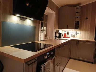 a kitchen with wooden cabinets and a counter top at Hytte-23 Cozy cabin close to Kvitfjell in Fåvang