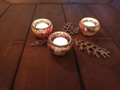 a group of three candles on a wooden table at Hytte-23 Cozy cabin close to Kvitfjell in Fåvang