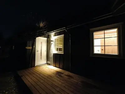 a dark room with a door and a window at Hytte-23 Cozy cabin close to Kvitfjell in Fåvang