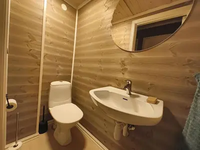 a bathroom with a toilet and a sink and a mirror at Hytte-23 Cozy cabin close to Kvitfjell in Fåvang