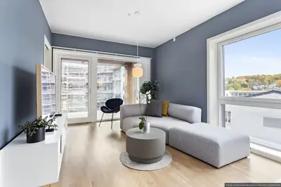 a living room with a couch and a table at Eksklusiv byleilighet med utsikt i Trondheim Sentrum in Trondheim