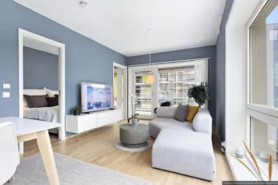 a living room with a couch and a tv at Eksklusiv byleilighet med utsikt i Trondheim Sentrum in Trondheim