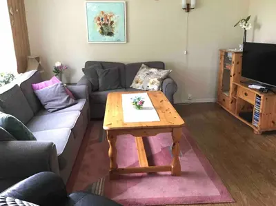 a living room with a couch and a coffee table at Oceanview House Ideal for Peaceful Holidays in Venøya