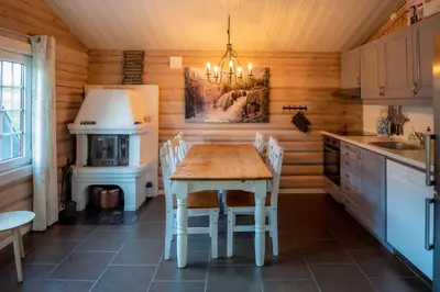 a kitchen with a table and a refrigerator at Vikinggrenda 21B in Trysil