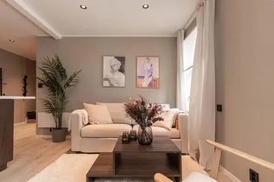 a living room with a couch and a table at DINBNB Apartments l 50 meters to Bryggen l New 2023 l Sunny backyard in Bergen