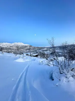 a snow covered field with footprints in the snow at Panorama ski inn out, jacuzzi,Badstu in Kvam