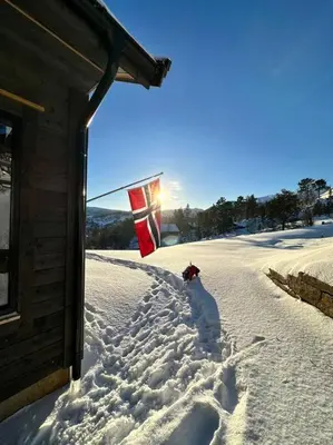 a flag in the snow next to a building at Panorama ski inn out, jacuzzi,Badstu in Kvam